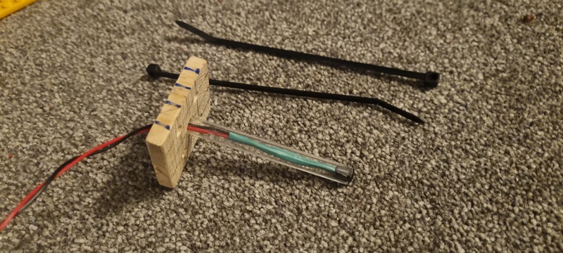 Monitoring Diesel (the Hamster)'s Movements - Reed switch and wheel spin sensor assesmbly (biro and a bit of wood) (credit: James Rowson).