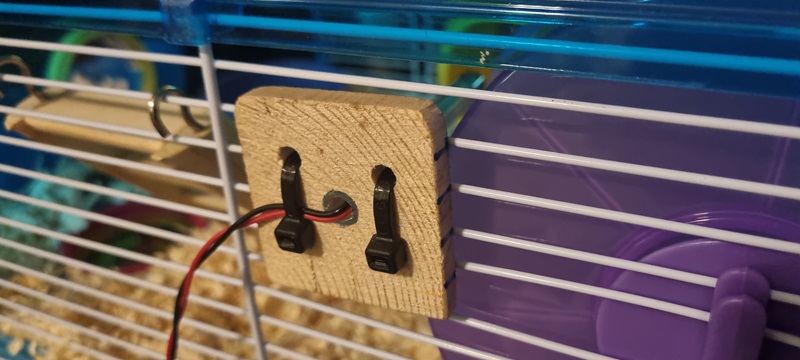 Monitoring Diesel (the Hamster)'s Movements - Wheel spin sensor cable tie'd onto the cage (credit: James Rowson).